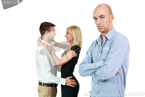 Image of young man unhappy jealous couple behind 