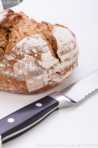 Image of fresh baked grain bead and knife isolated