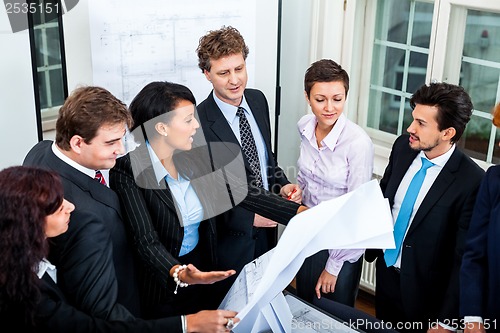 Image of business people discussing architecture plan sketch 