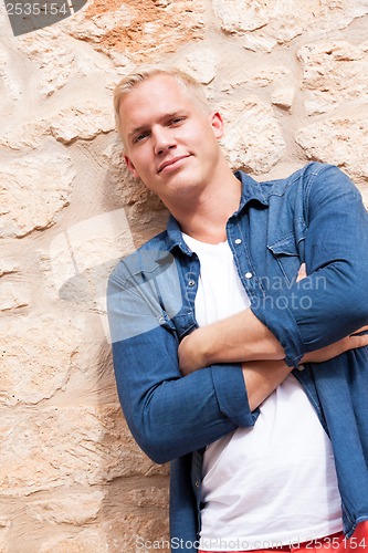 Image of attractive young adult man standing outside 