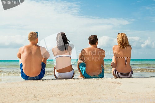 Image of young happy friends havin fun on the beach