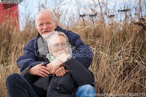 Image of happy mature couple relaxing baltic sea dunes 