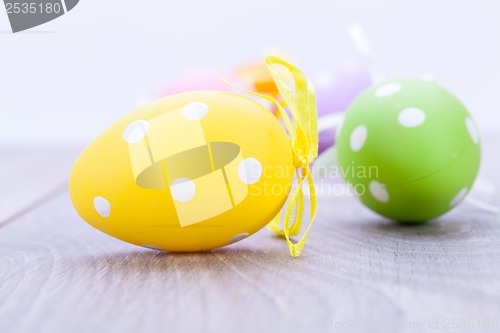 Image of colorful easter egg decoration on wooden background