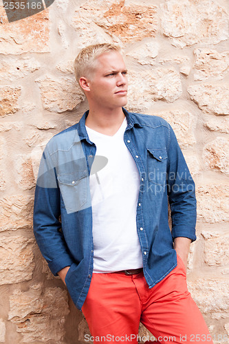 Image of attractive young adult man standing outside 