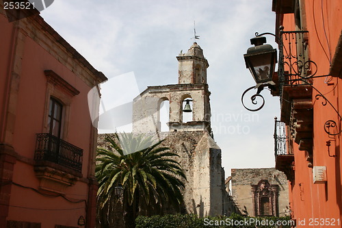 Image of Street with church and palm tree, Mexico