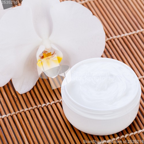 Image of cosmetic face cream on wooden background 