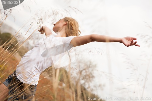 Image of young happy attractive woman arms wide open 