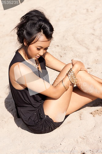 Image of beautiful asian woman with colorful makeup on the beach 