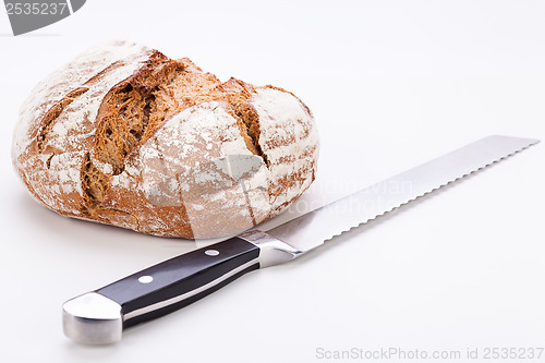 Image of fresh baked grain bead and knife isolated