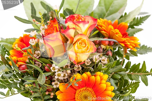 Image of Vivid orange gerbera daisy in a bouquet