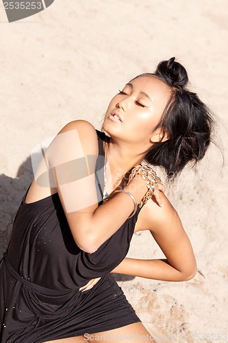 Image of beautiful asian woman with colorful makeup on the beach 