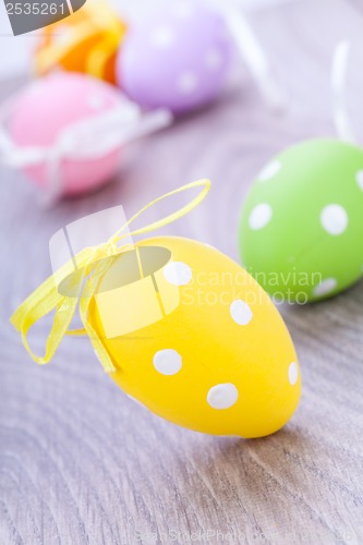 Image of colorful easter egg decoration on wooden background