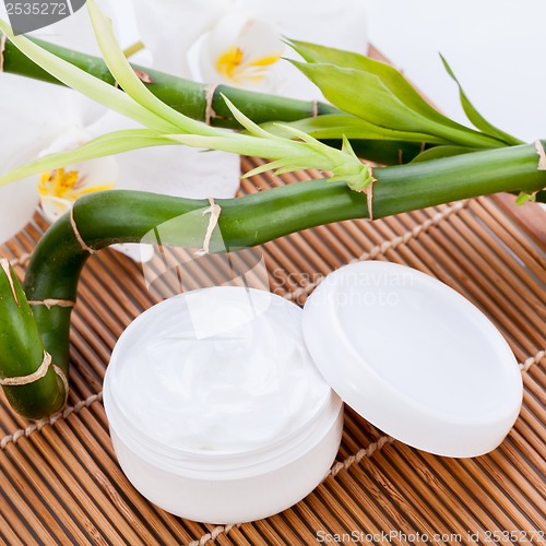 Image of cosmetic face cream on wooden background 