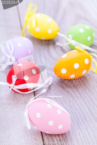 Image of colorful easter egg decoration on wooden background