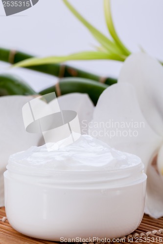 Image of cosmetic face cream on wooden background 