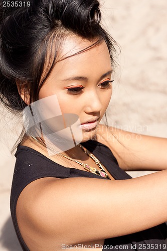 Image of beautiful asian woman with colorful makeup on the beach 