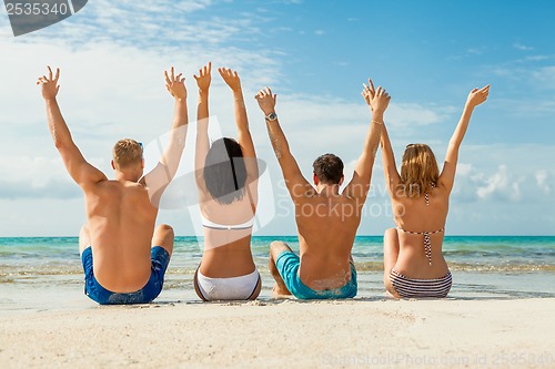 Image of young happy friends havin fun on the beach