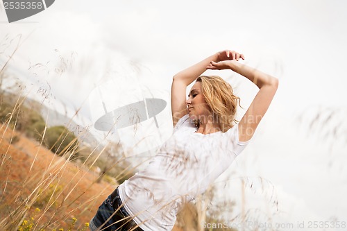 Image of young happy attractive woman arms wide open 