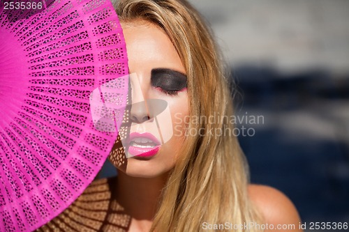 Image of young beautiful woman with smokey eyes and pink lips