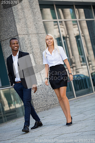 Image of young successful business man and woman outdoor