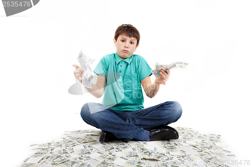 Image of boy sitting on money