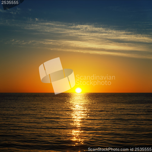 Image of dark water and sun over it