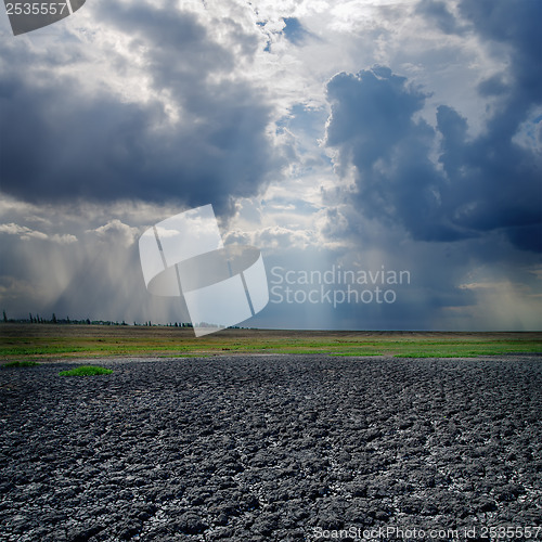 Image of drought land and dramatic sky with clouds