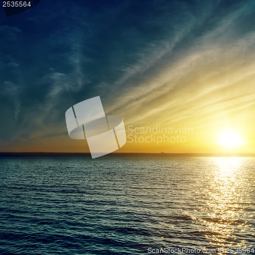 Image of sunset with clouds over water