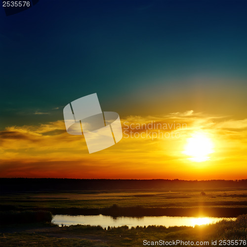 Image of blue and orange sunset over lake