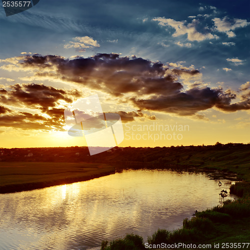 Image of cloudy sunset over river