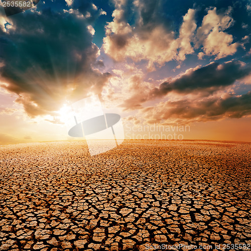 Image of cracked desert and dramatic sunset