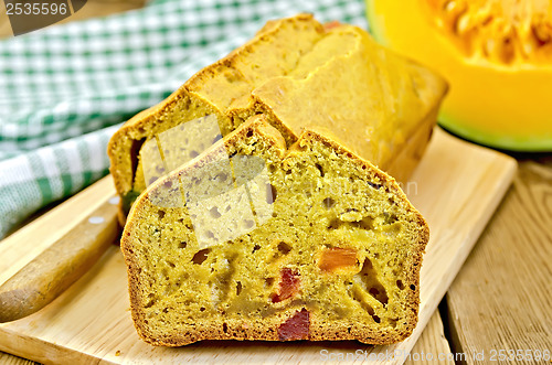 Image of Fruitcake pumpkin with candied fruit and a napkin on a board