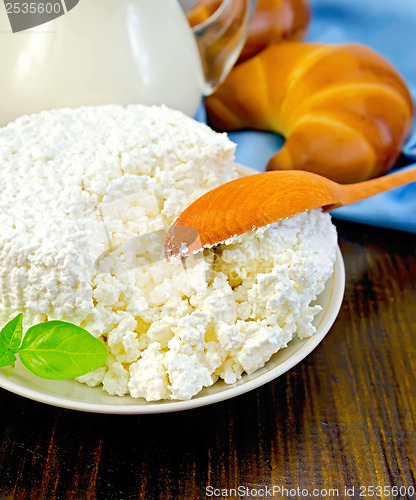 Image of Curd on a saucer with a spoon on a board