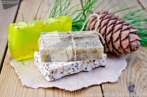 Image of Soap different with cedar cones on a board