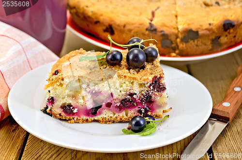 Image of Pie with berries of black currant and knife on board