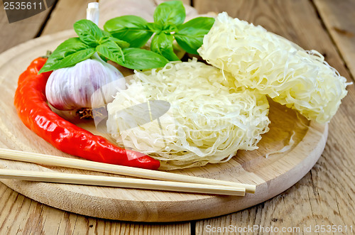 Image of Noodles rice stranded with spices on the board