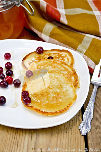Image of Flapjacks with cranberry in a plate on a board