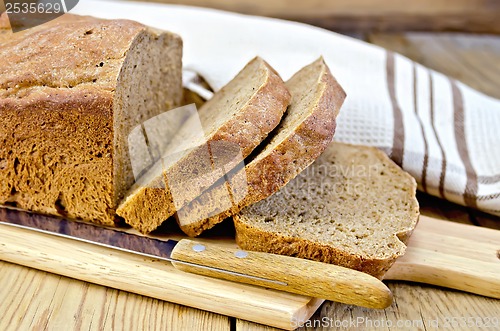 Image of Rye homemade bread sliced on the board with a napkin