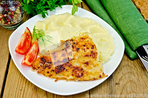 Image of Fish fried with mashed potatoes on a board