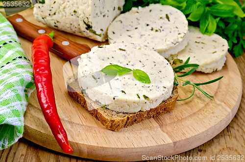 Image of Sandwich with homemade cheese and pepper on the board