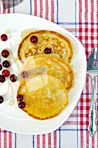 Image of Flapjacks with cranberry in a plate on a napkin