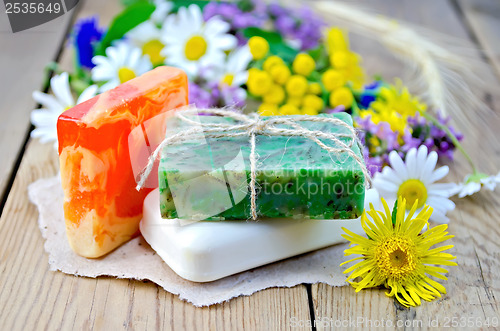 Image of Soap homemade with wildflowers on the board