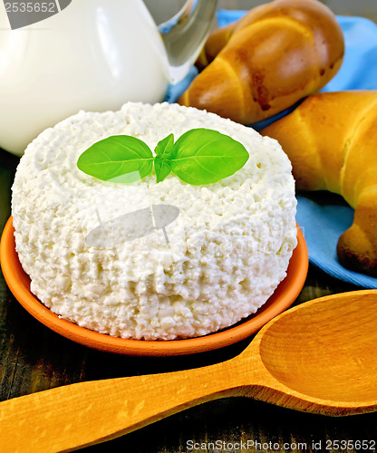 Image of Curd with milk and spoon on a board