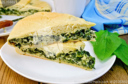 Image of Pie with spinach and cheese on the board