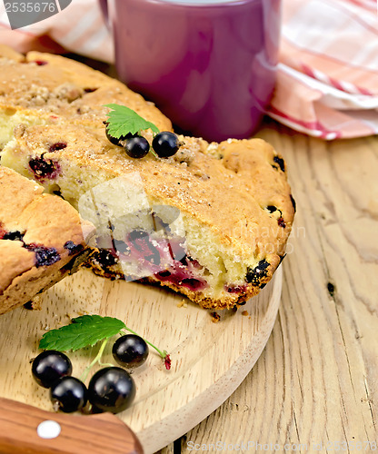 Image of Pie with berries of black currant on a board