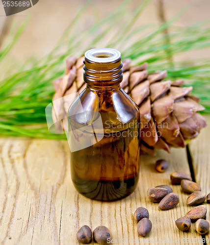 Image of Oil with cedar cone and nuts on the board