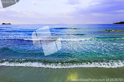 Image of waves of sea on the sandy beach