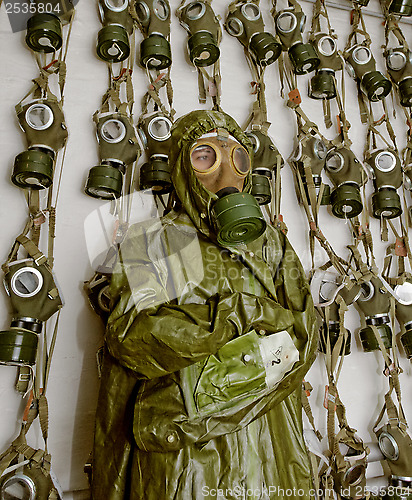 Image of old military gas on a chemical protective suit woman 