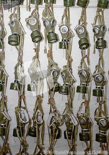 Image of old military gas masks hanging