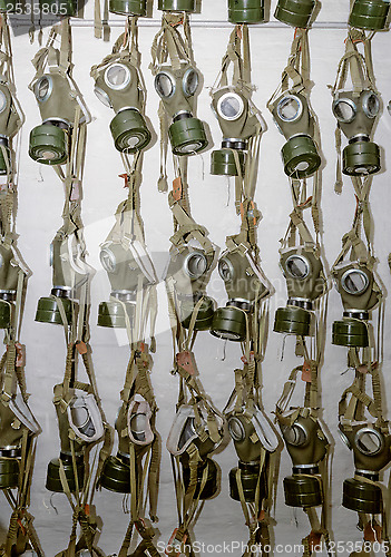 Image of old military gas masks hanging